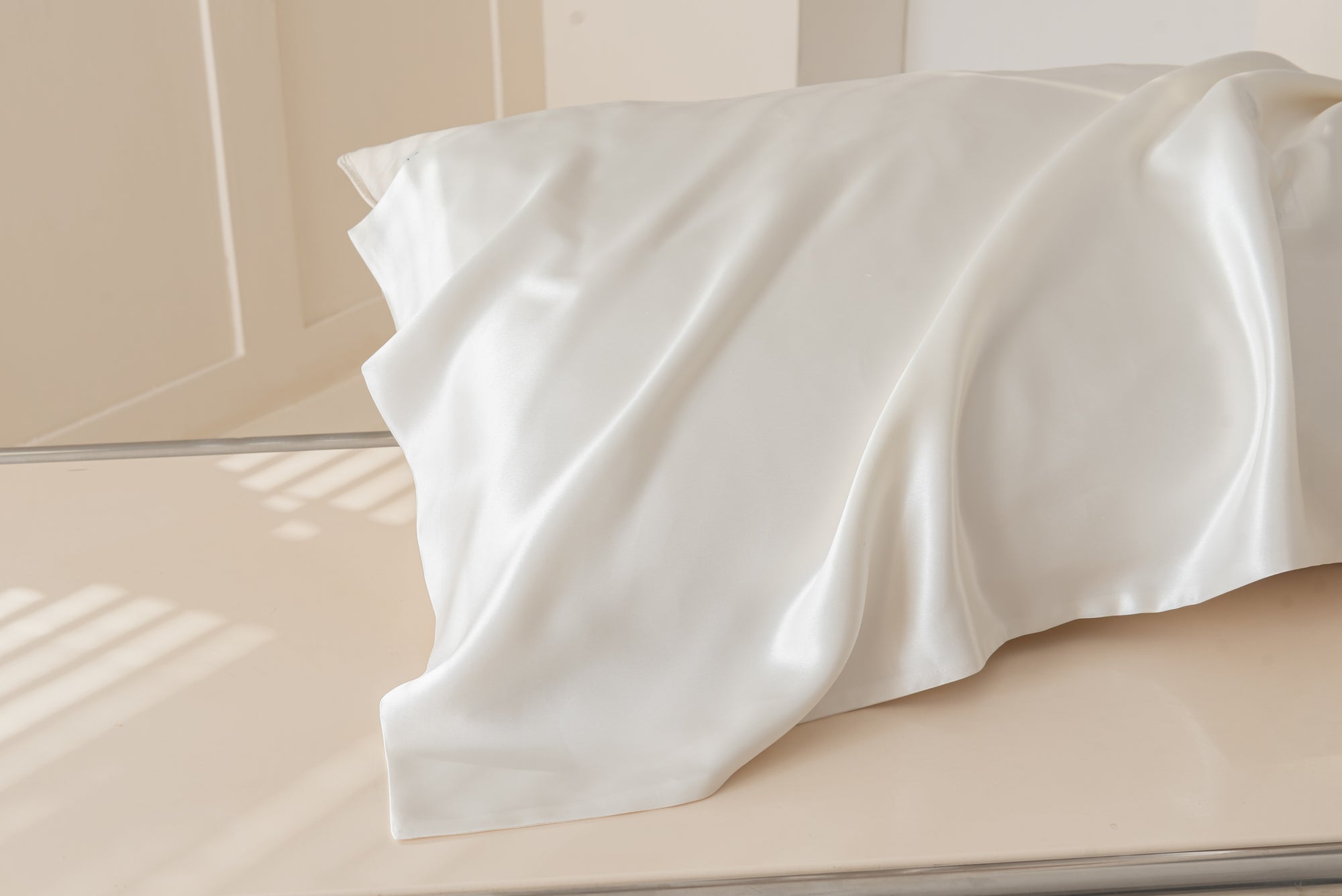 Ivory mulberry silk pillowcase catching soft morning window light